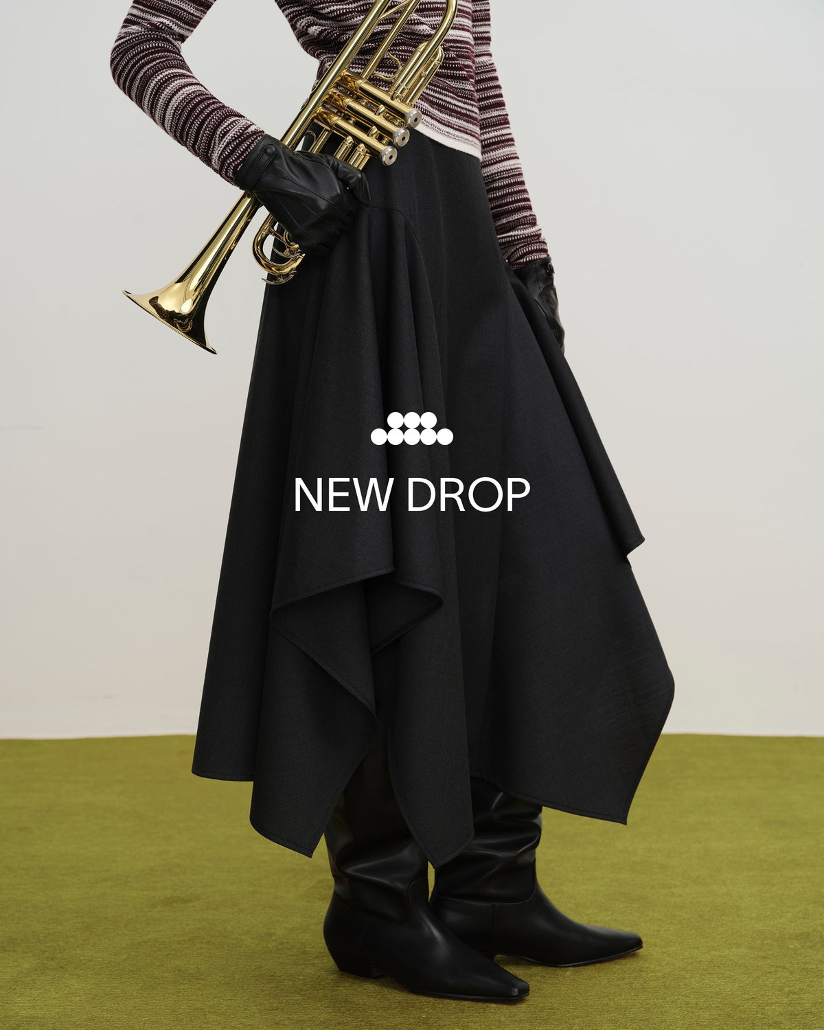 Future Classics D2 hero left: black asymmetric drape skirt, symbol and NEW DROP